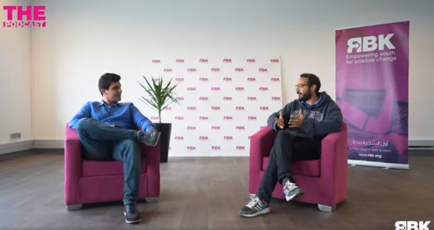 Amine Riahi in conversation with the host on the Rebootkamp (RBK) podcast set