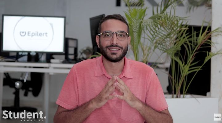 Amine Riahi seated in the Epilert office with clasped hands, Student Magazine interview