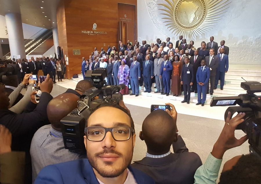 Selfie in the Nelson Mandela Plenary Hall lobby at the African Union in Addis Ababa, with a group photo of delegates behind